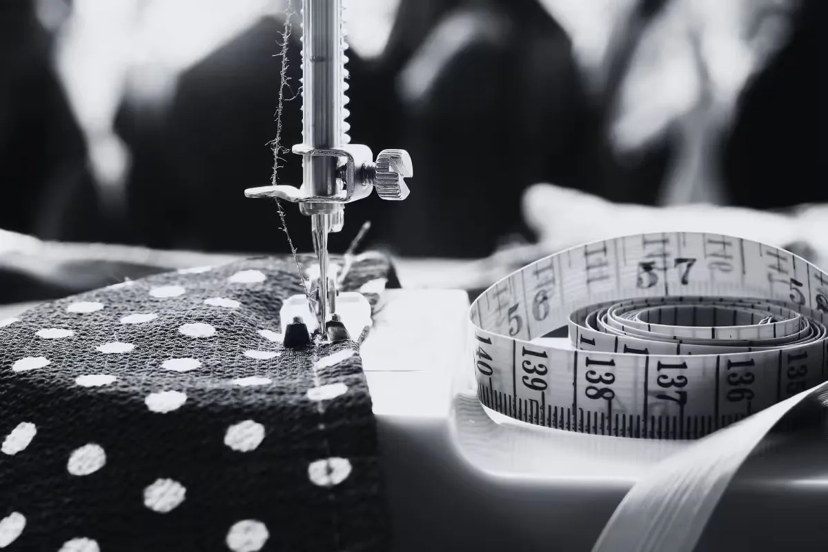 Woman Cutting and Sewing Clothing
